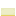 The side of the lemon cake texture. It is light yellow with a sliver of dark yellow at the bottom.