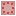 The top of the strawberry cake texture. It is light pink with pink squares arranged in a circle.