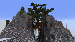 A large mountain split down the center with a large tree connecting the two sides.